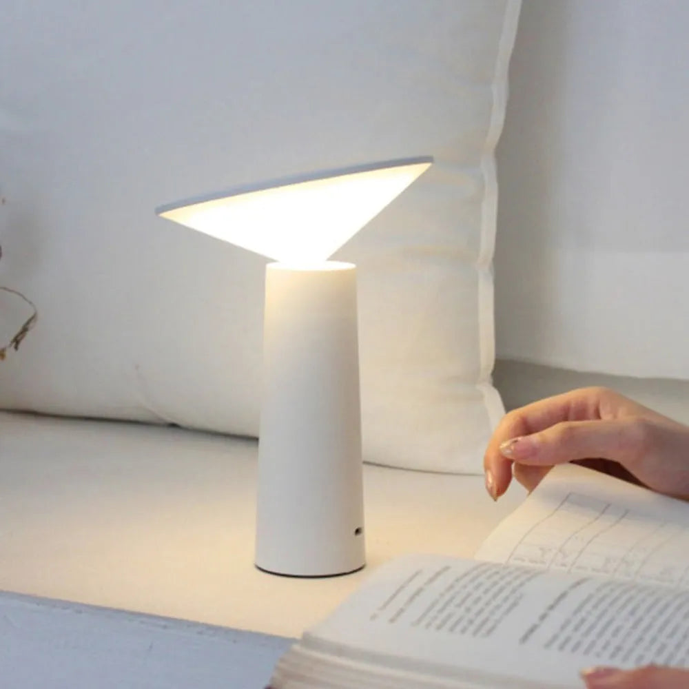 Black USB LED table lamp with touch controls and adjustable lamp head on wooden desk