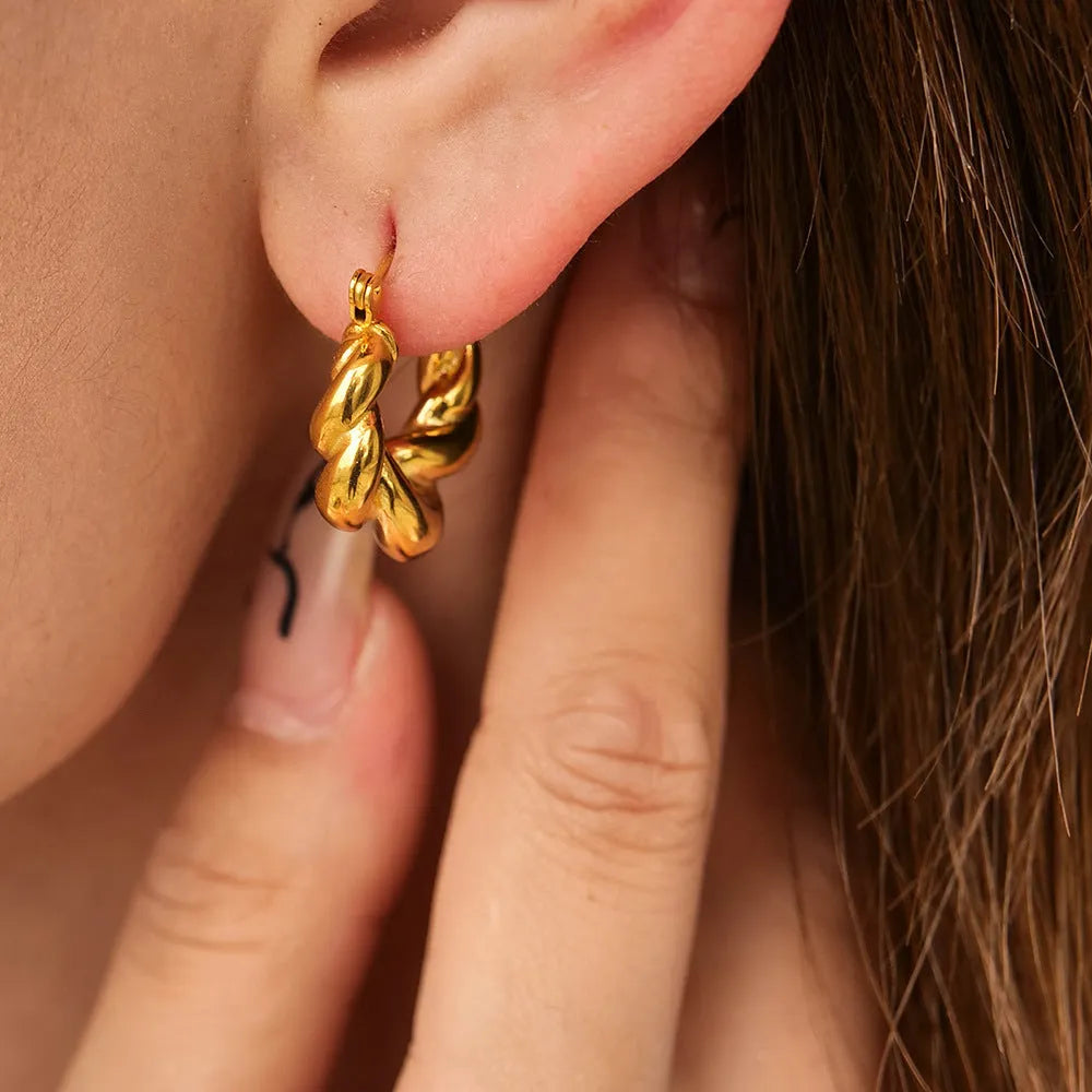 18K gold titanium steel geometric ellipse ear clip for women, light luxury style, on a model