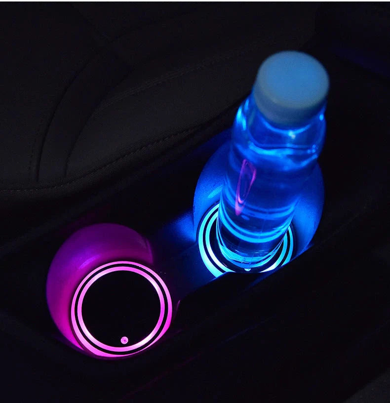 Colorful car cup holder with LED lights that can be charged via USB or solar power, providing a customizable ambient glow for your vehicle's interior