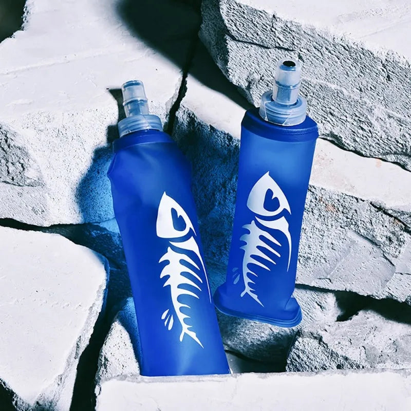 Blue sports soft water bottle with silicone lid on outdoor ground