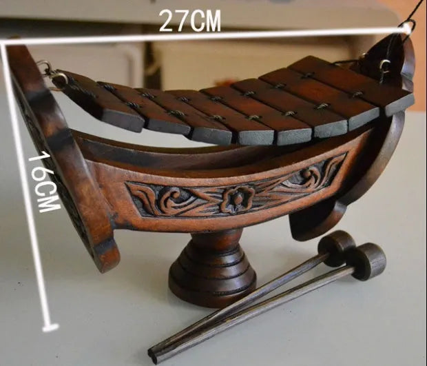 Brown wooden hand xylophone decorative pendant measuring 27x16cm in Southeast Asian style