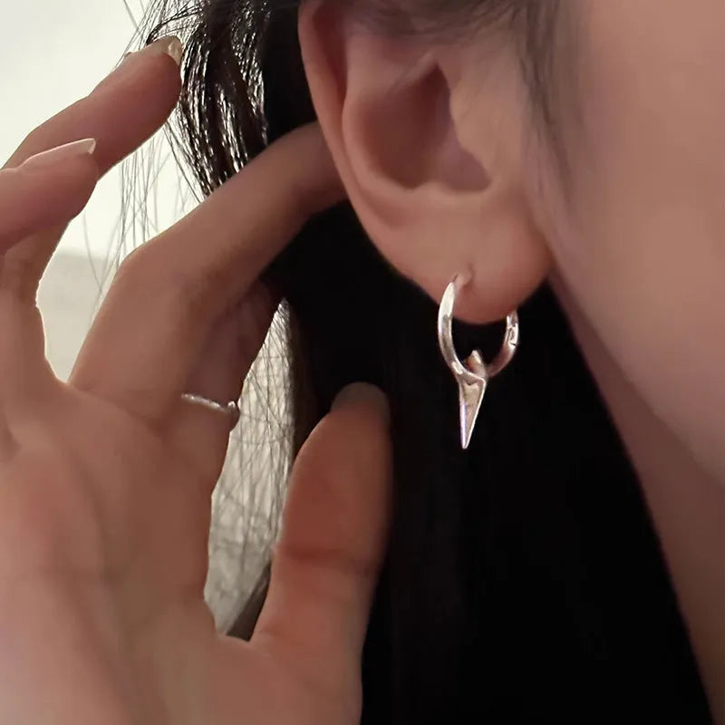 Gold plated geometric star earrings with copper construction and XINGX ear clip design