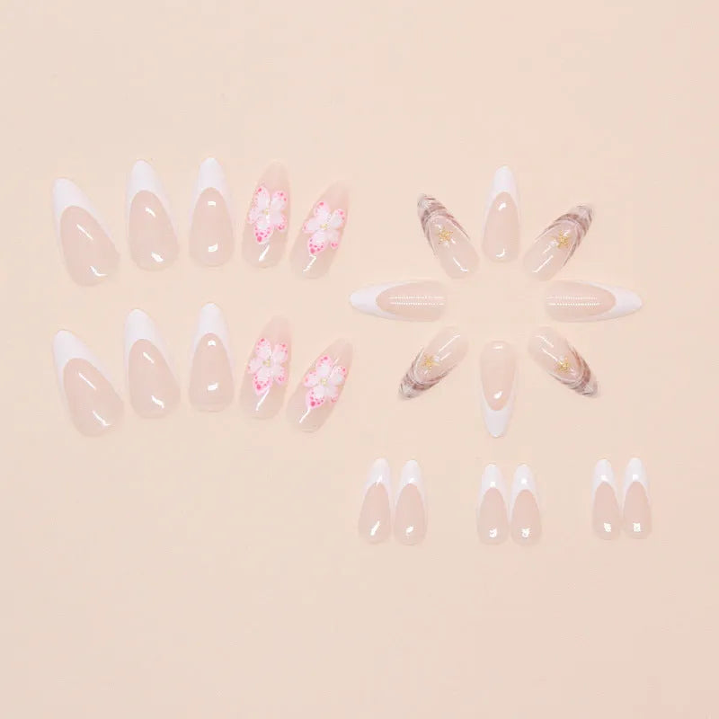 French style fake nails with simple flower patterns and rock accents on white background