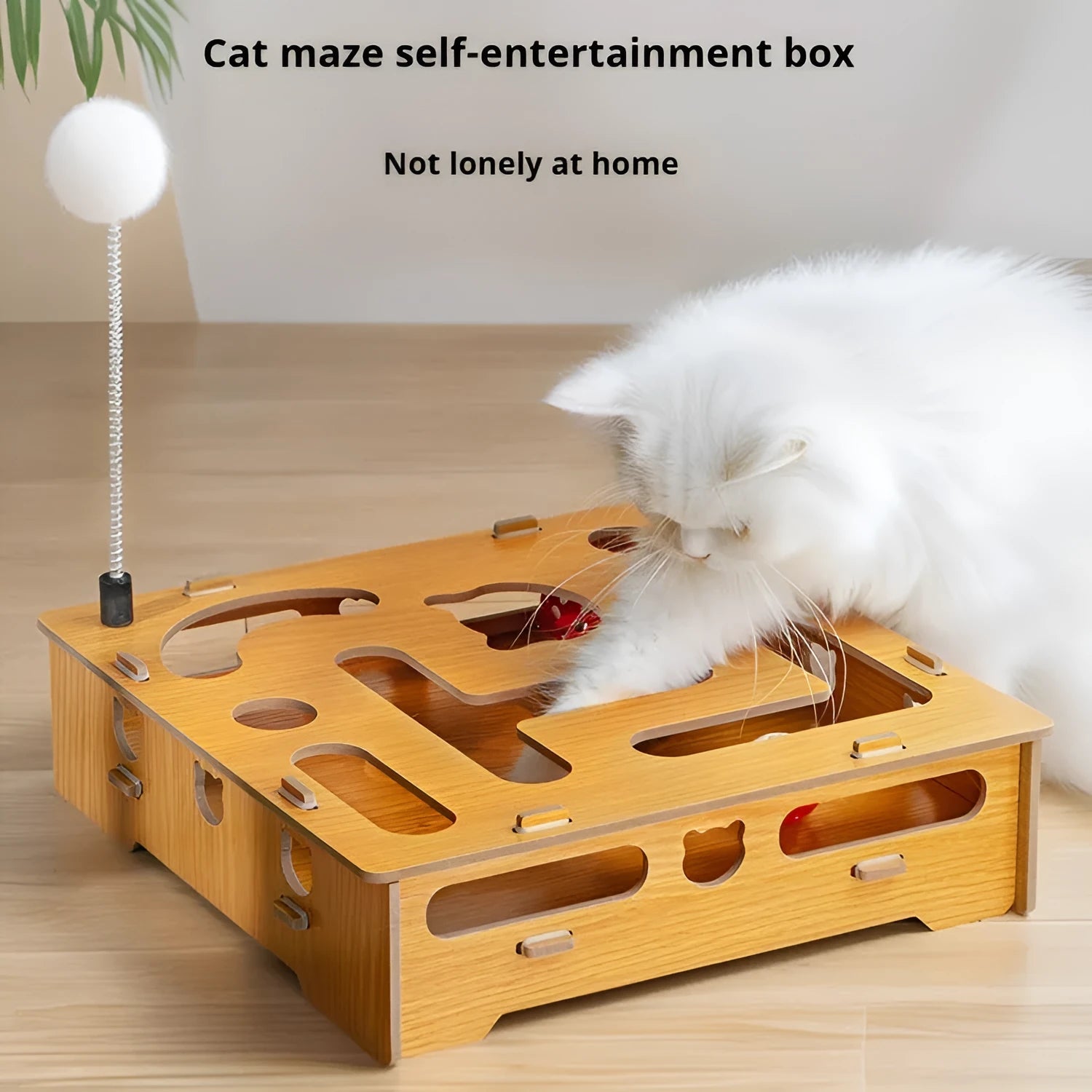 Wooden cat maze box with teasing stick and two bell balls on a floor