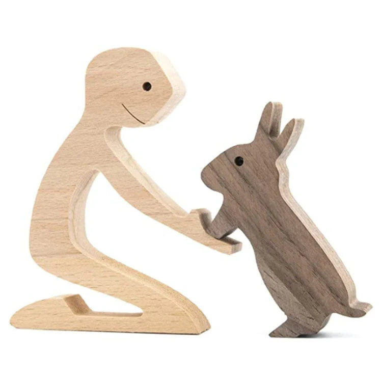 Handcrafted wooden dog sculpture featuring a man and his loyal canine companion