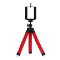 Black flexible octopus tripod with coiled legs next to a smartphone, showing its 18cm size.