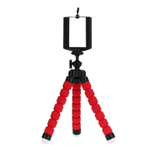 Black flexible octopus tripod with coiled legs next to a smartphone, showing its 18cm size.
