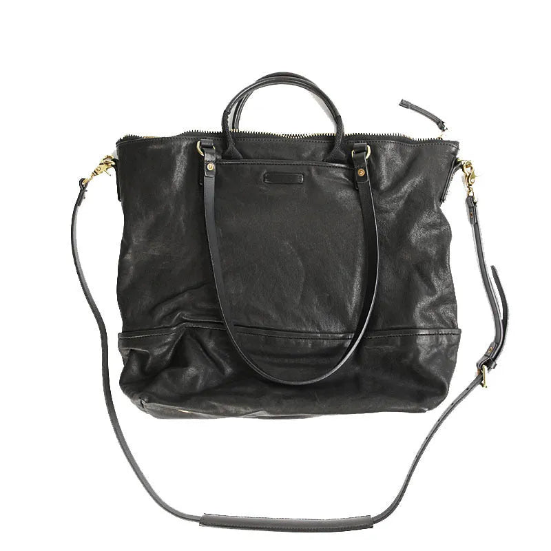 Black handmade vegetable tanned cowhide tote bag with zipper closure and 15-inch computer slot for daily outdoor use