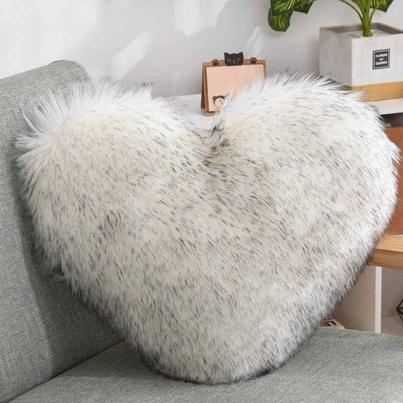 Plush heart-shaped throw pillows in various colors and styles for cozy sofa decor