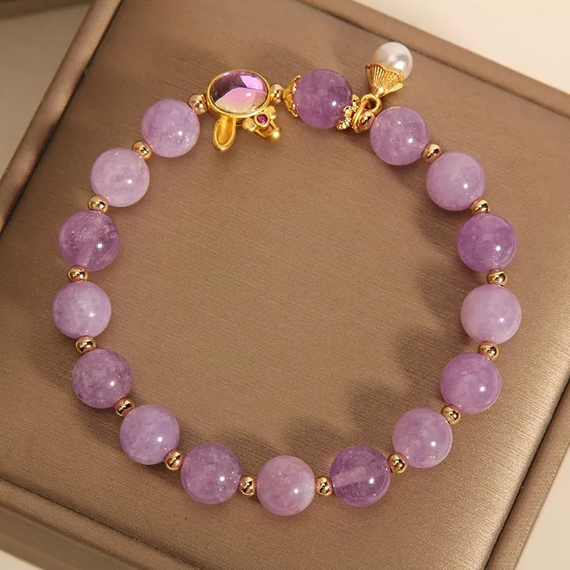 Natural mauve jade rabbit bracelet with crystal band and purplish red hare head charm.