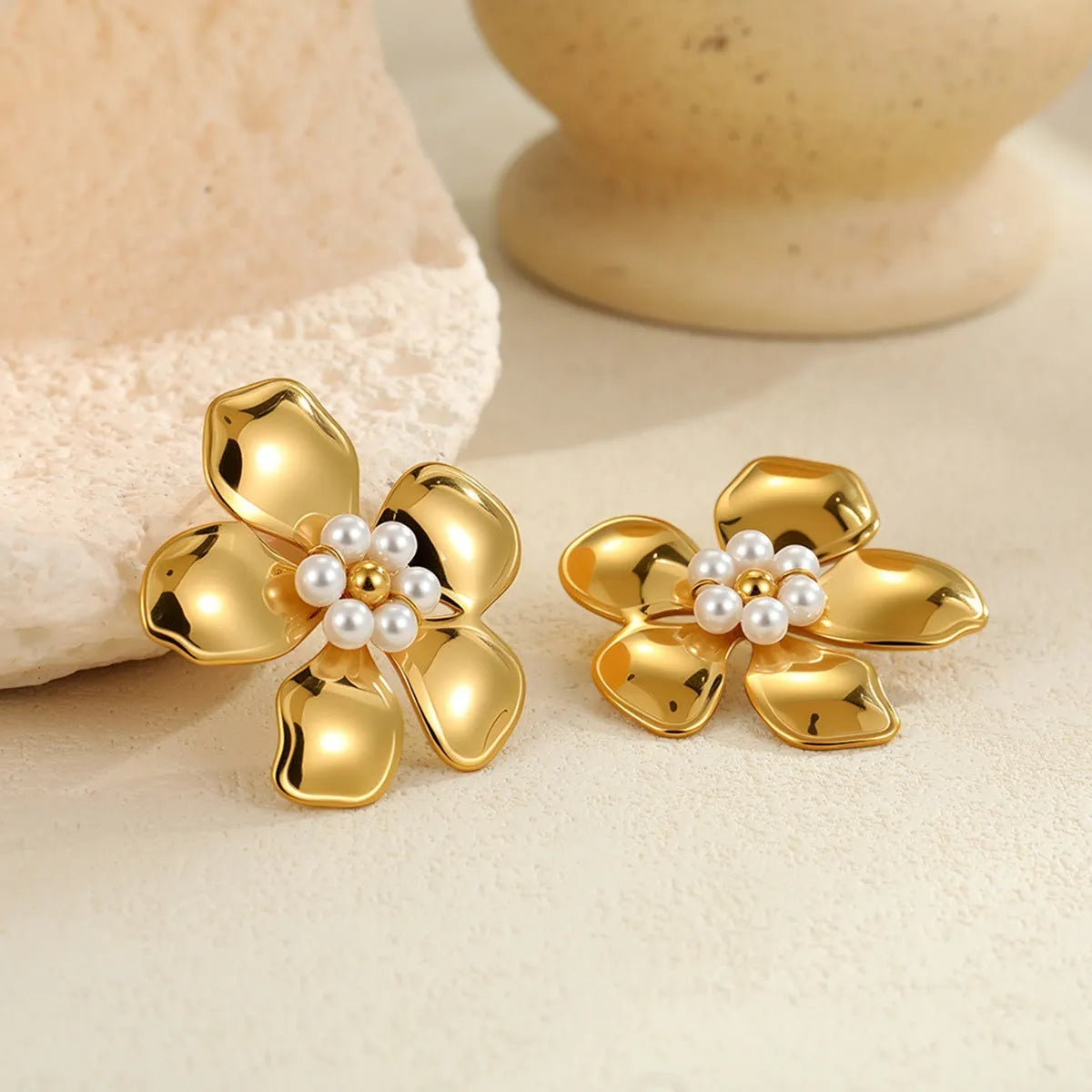Flower stringed pearls stud earrings in gold and steel colour on white background