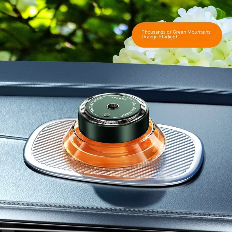 Black smart automatic spray car air freshener device with a 50 ml refill cartridge mounted on a car vent.