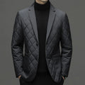 Man wearing a thick black lapel down jacket with side seam pockets.