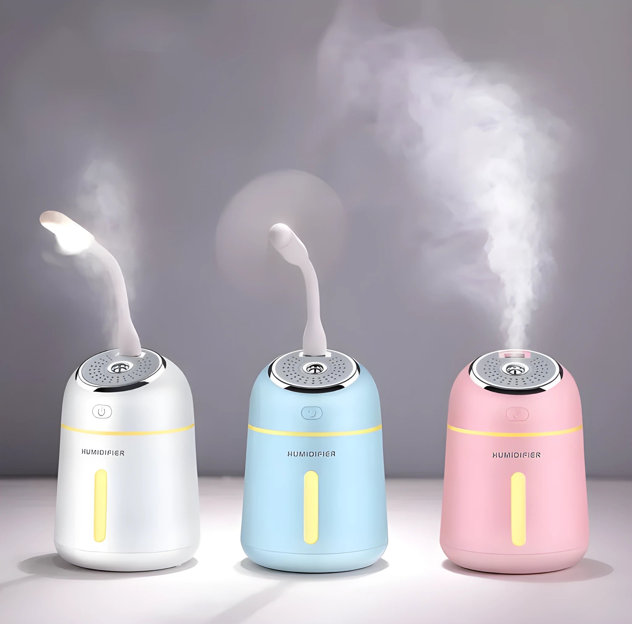 Mini ultrasonic humidifier 330ml four-in-one USB with LED light and fan in blue, pink and white on desk