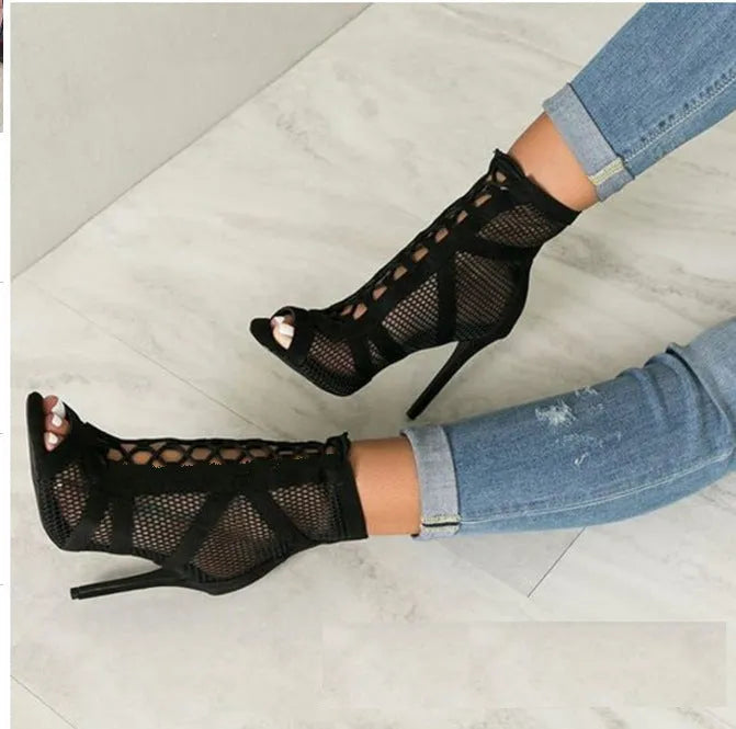 Black suede women's high heel shoes with 11.5cm stiletto heel and pointed toe on a light background
