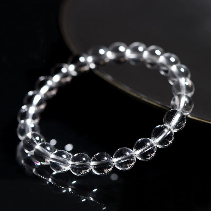 Natural Donghai old mine white crystal round bead bracelet with geometric design on a wrist.