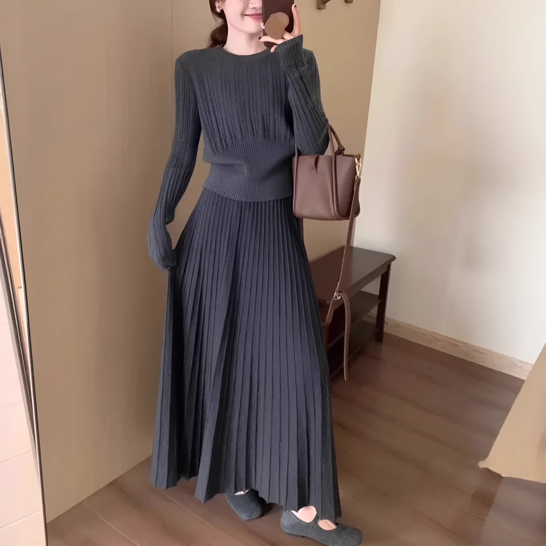 Dark grey knitted dress suit set with 3D pattern, featuring a sweater and skirt.
