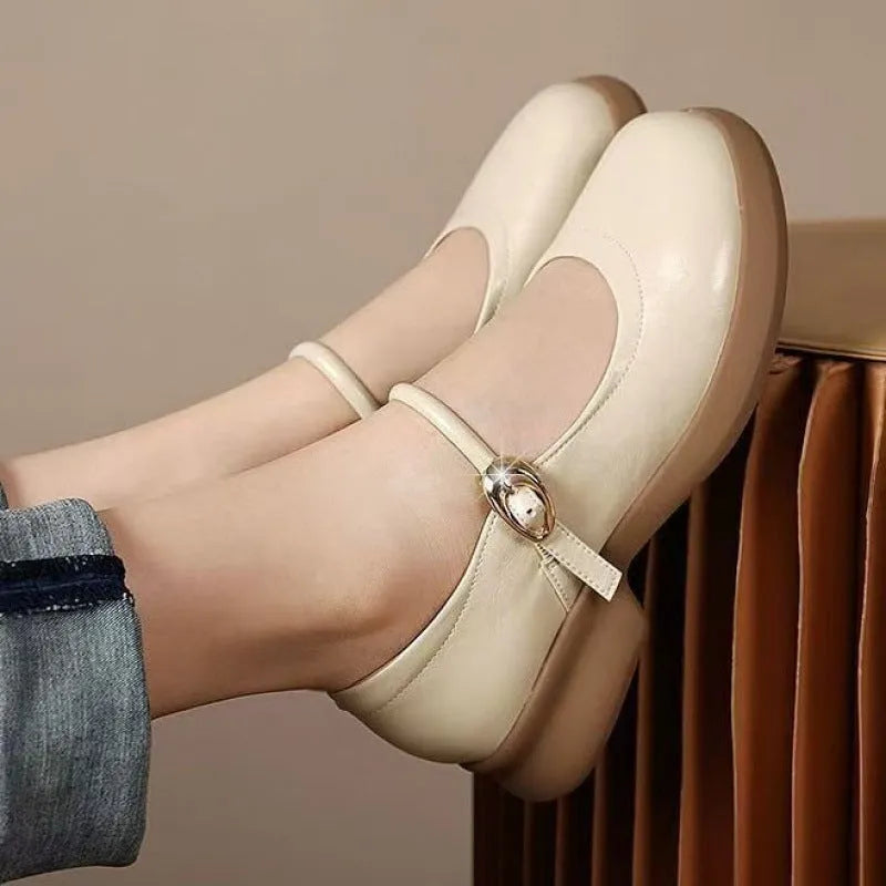 Flat black cheongsam leather shoes with a white skull pattern on the toe and a light brown wedge heel.