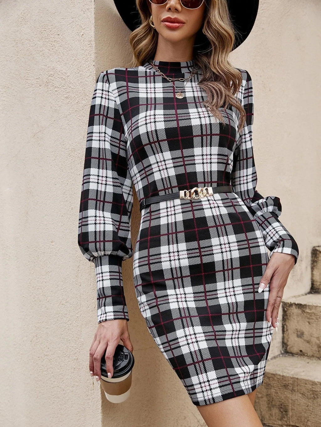 Black women's tight dress with lantern sleeves and leather stitching detail on the front.
