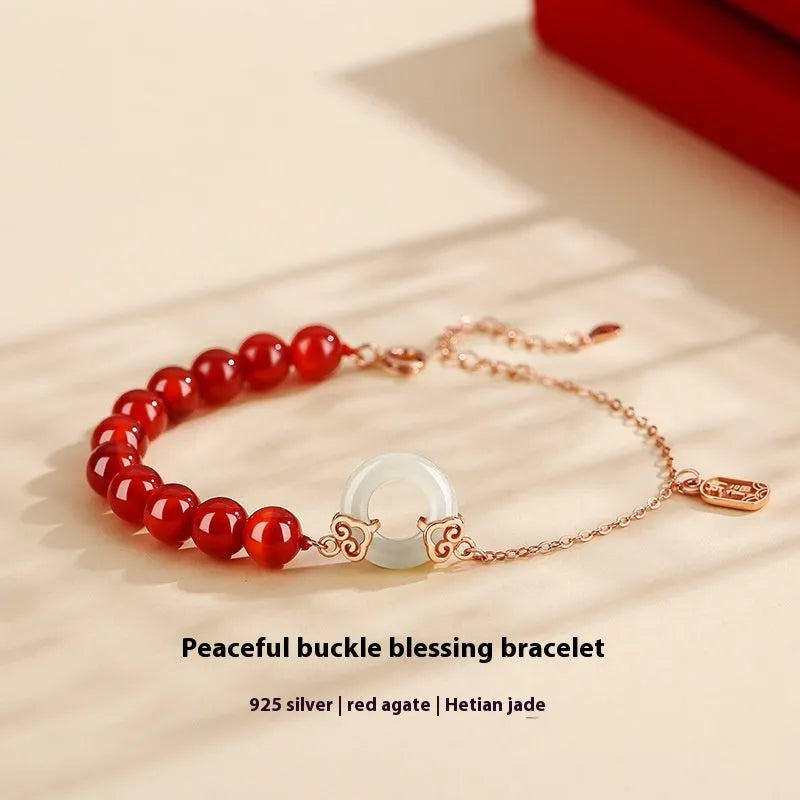 Close-up of a women's sterling silver bracelet with a peace buckle and engraved Chinese cloud and character motifs.