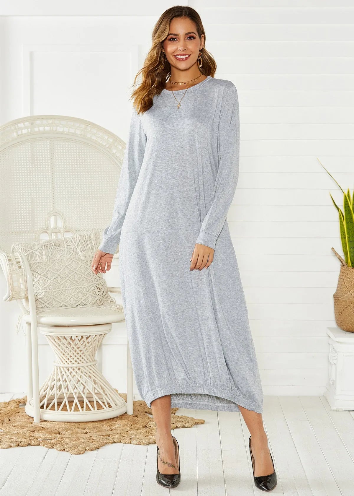 A loose, black lantern-style dress with a lace-up detail on the crew neckline.