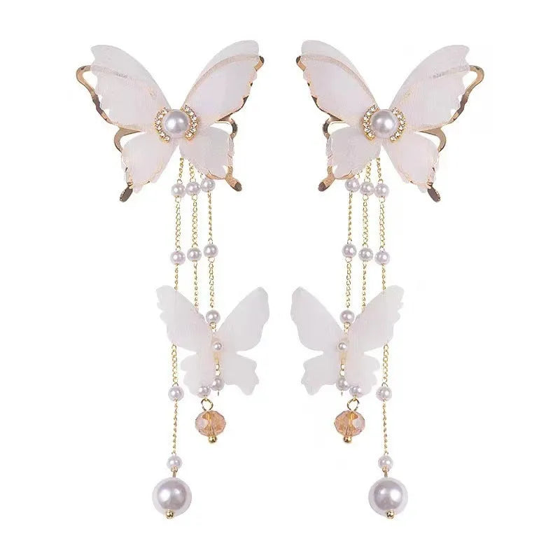 White butterfly earrings with lace tassel, pearl accents and rhinestones on copper alloy