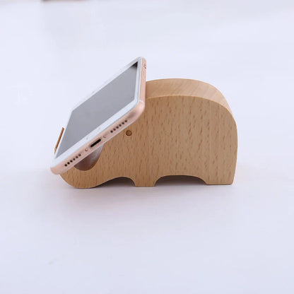 Custom lettering beech wood lazy phone holder with coin slot on a wooden table