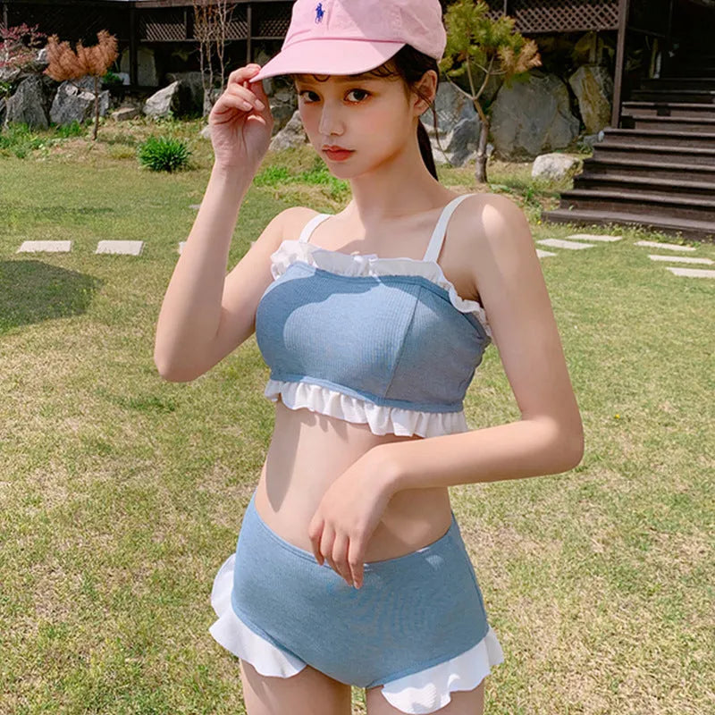 Women's conservative one-piece swimsuit with suspenders in a solid colour.