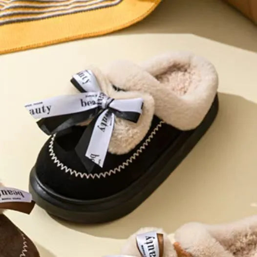 Beige women's ribbon bow half slipper with suede upper and thick sole on a neutral background