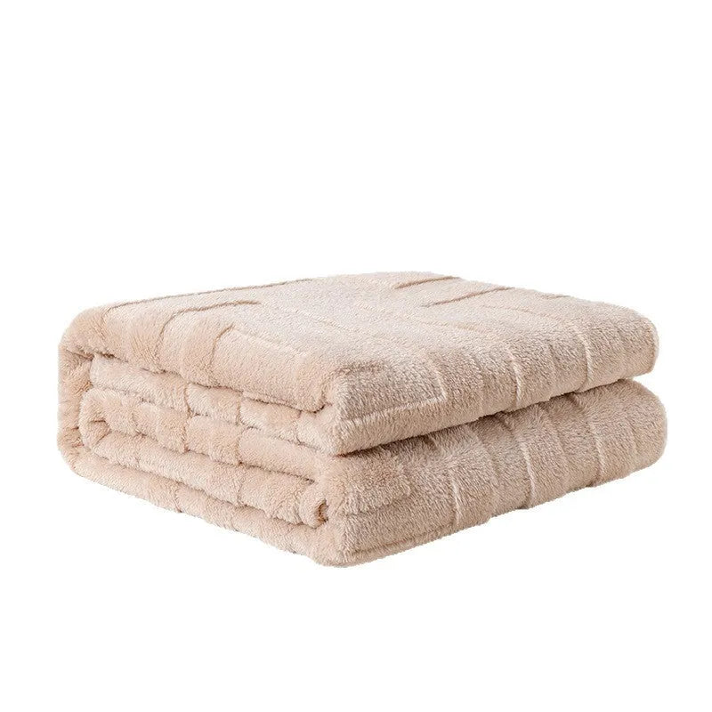 Thick coral fleece square blanket in a modern solid colour, draped over a sofa.