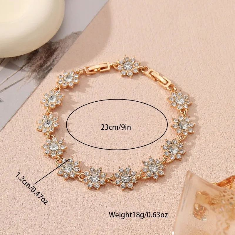 Electroplated zinc alloy bracelet with flower-shaped design and coloured gem elements in metallic finish