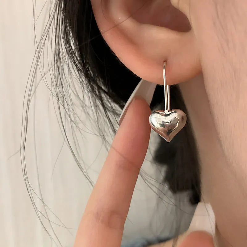Korean-style silver heart earrings with three-dimensional design and glossy finish