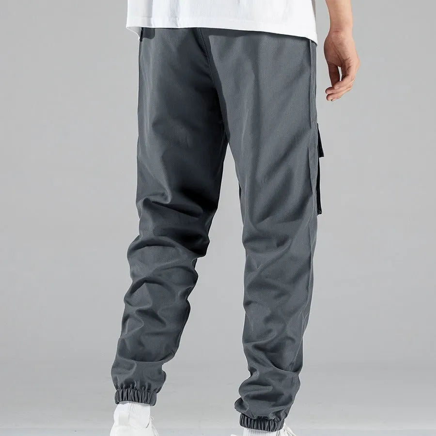 Men's multi-pocket workwear trousers in army green with drawstring waist, side and back pockets, straight leg cut