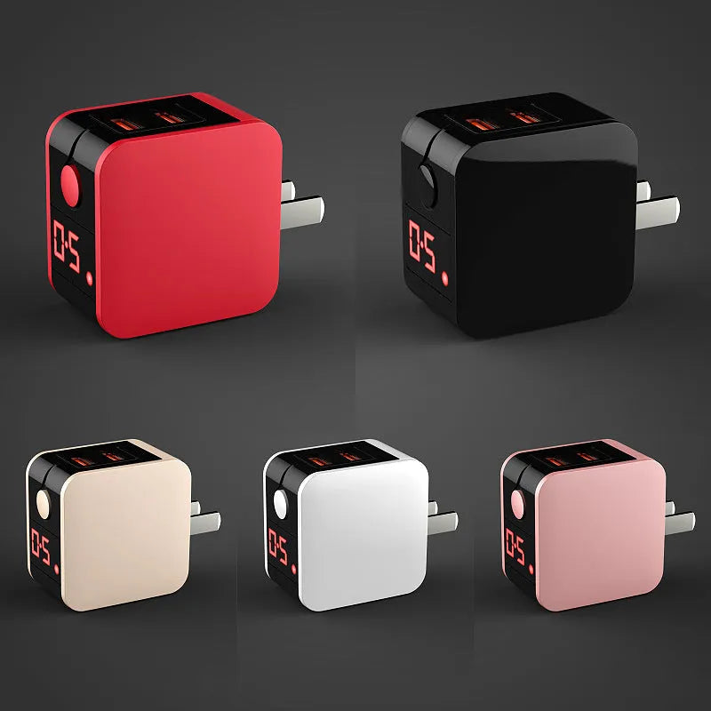 Black 5V 2.4A dual USB travel charger with digital display plugged into a wall socket.