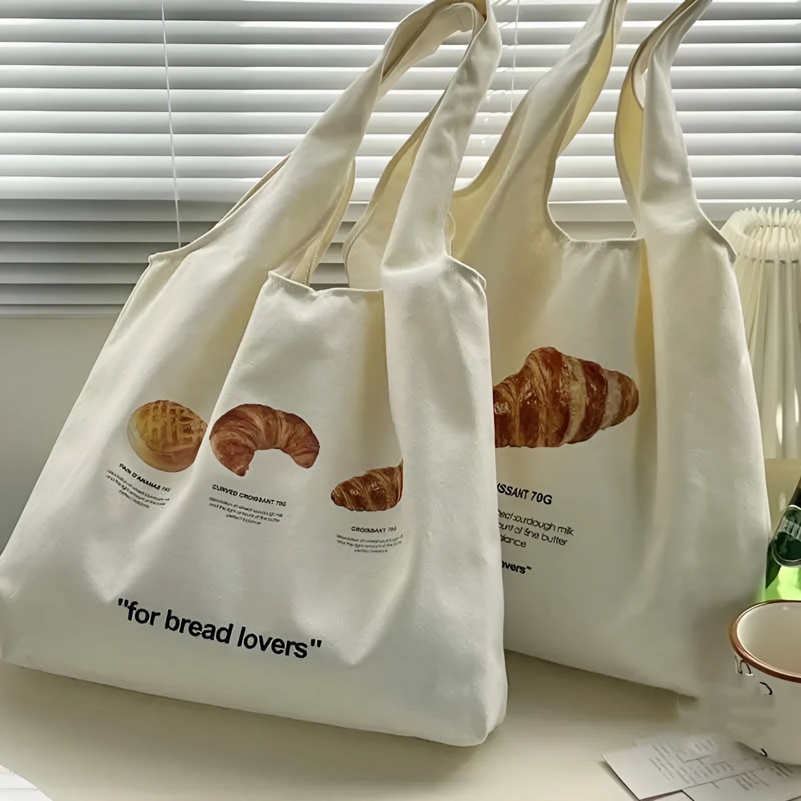 Beige canvas shoulder bag with bread design showing front width and shoulder strap