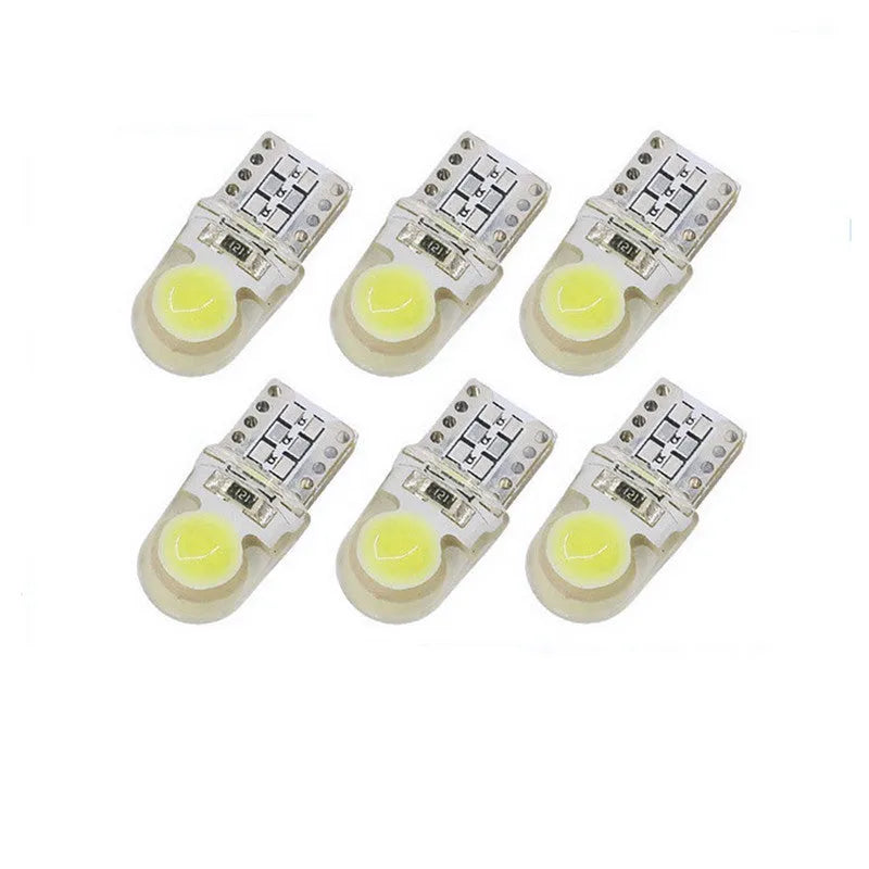 Ten silicone T10 LED car bulbs in various colours including white, red, blue, and yellow on a white background.