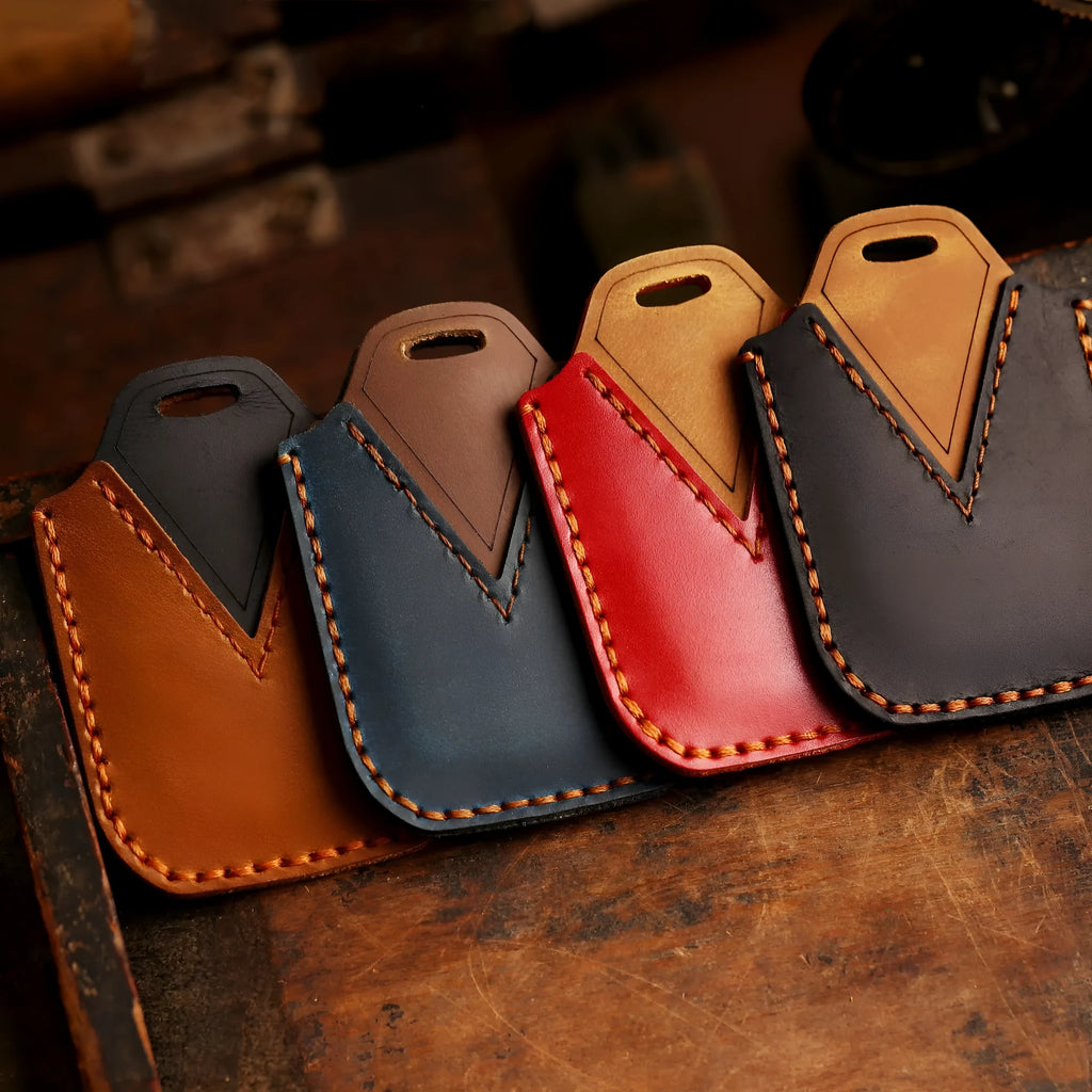 Full leather cowhide car key case in brown, three-button configuration, held in hand