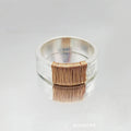 Silver golden geometric coil copper ring for men and women on a grey background.