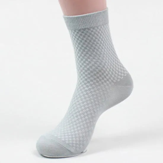 A pair of men's bamboo fibre ankle socks with a small square pattern, shown in one of the five available colours.