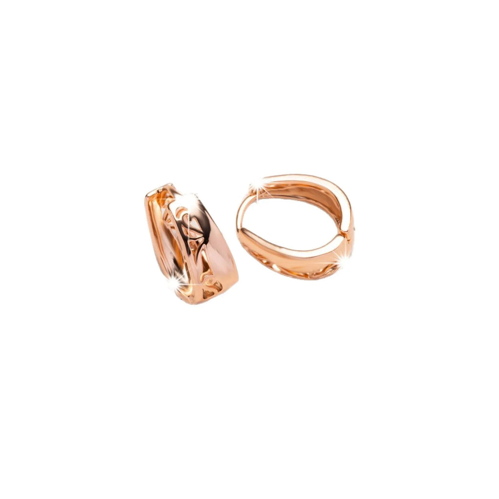 Rose gold copper hollow carved U-shaped women's earrings on a neutral background