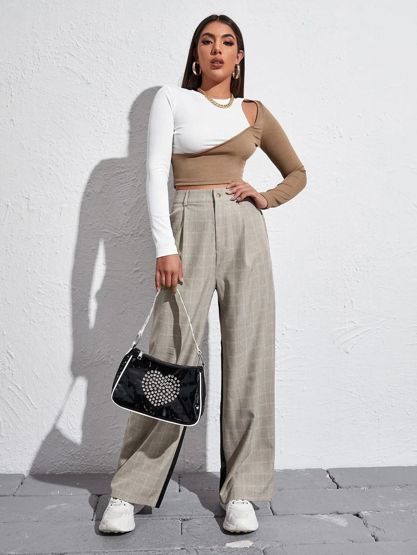 A colorblock strapless cropped tee with a ribbed-knit texture and cut-out details for a trendy, eye-catching look.