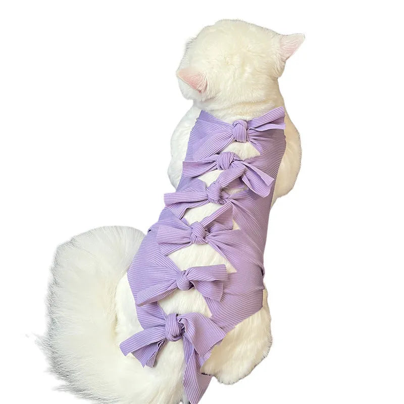 Adjustable lace-up polyester recovery suit for a cat after spaying surgery, shown in blue.