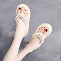 Women's high-heeled flip flops in beige and black with cotton cloth upper, showing casual summer sandal design
