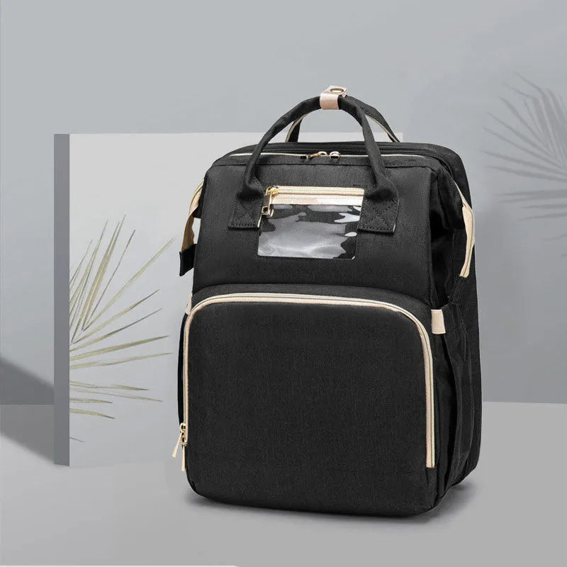 USB charging folding baby bed backpack with mattress in black, showing backpack and crib setup