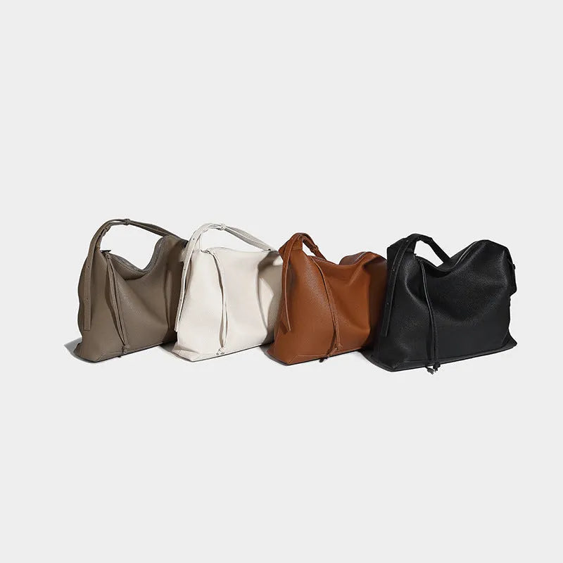 Large soft PU messenger bag in caramel colour showing shoulder strap and dimensions