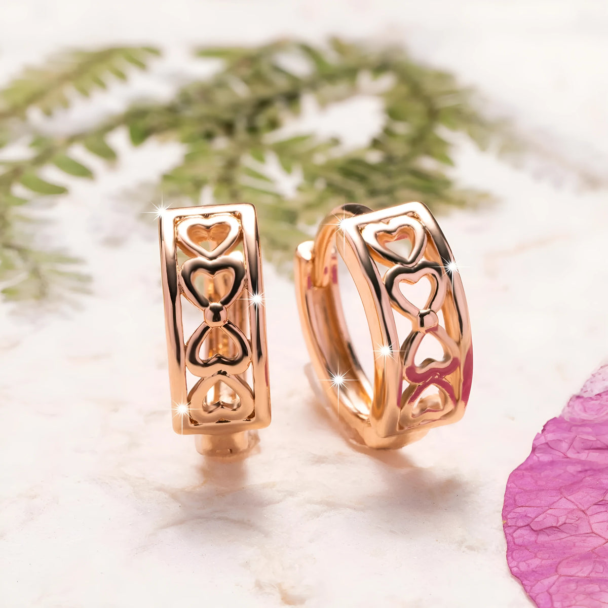 Love Glossy Hollow Ear Clip in rose gold copper electroplated earrings on display