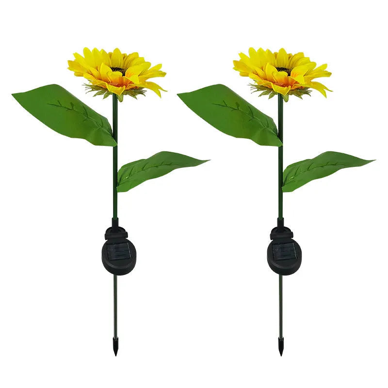 Yellow LED solar sunflower lamp on a lawn with a 66cm stem and 15cm flower head