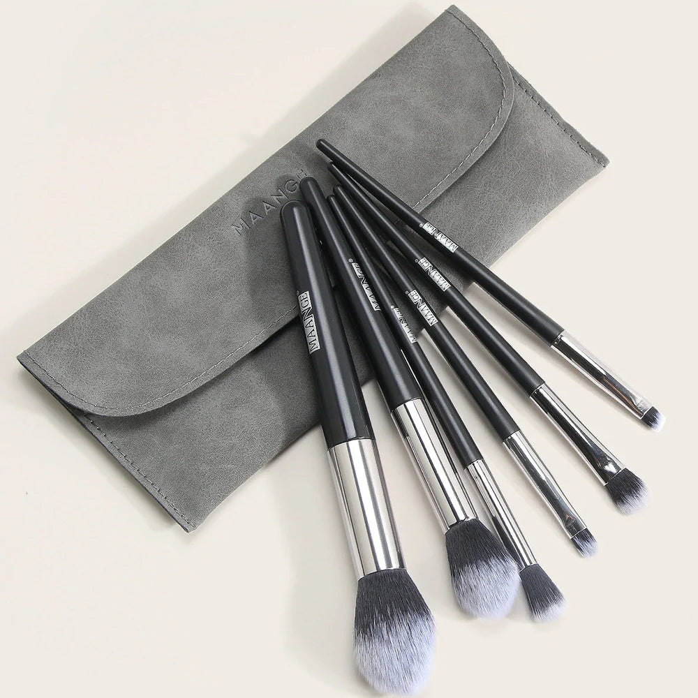 Six makeup brushes with black synthetic bristles and natural wood handles measuring 15cm