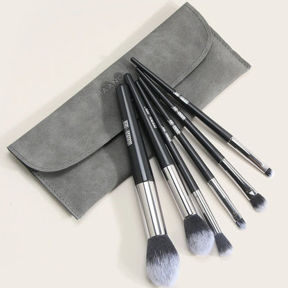 Six makeup brushes with black synthetic bristles and natural wood handles measuring 15cm