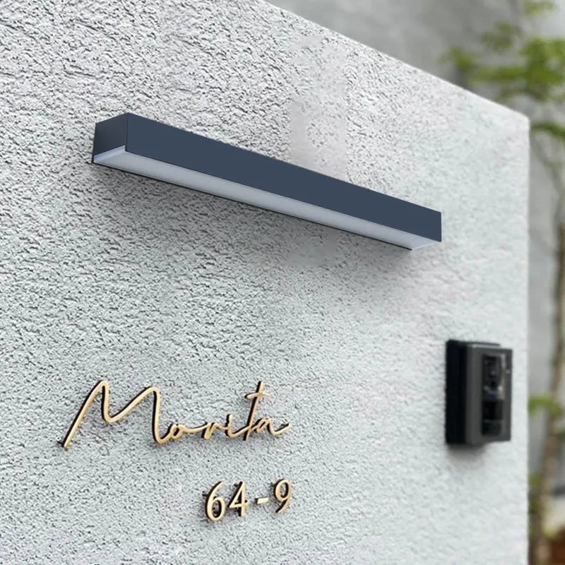 Black solar-powered outdoor wall lamp with IP65 waterproof rating for garden and patio lighting